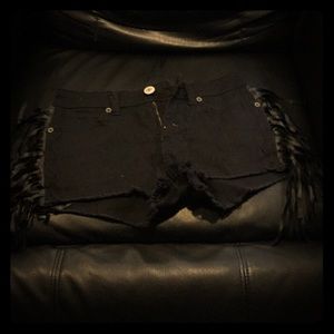 Black pair of shorts with blac leather strings